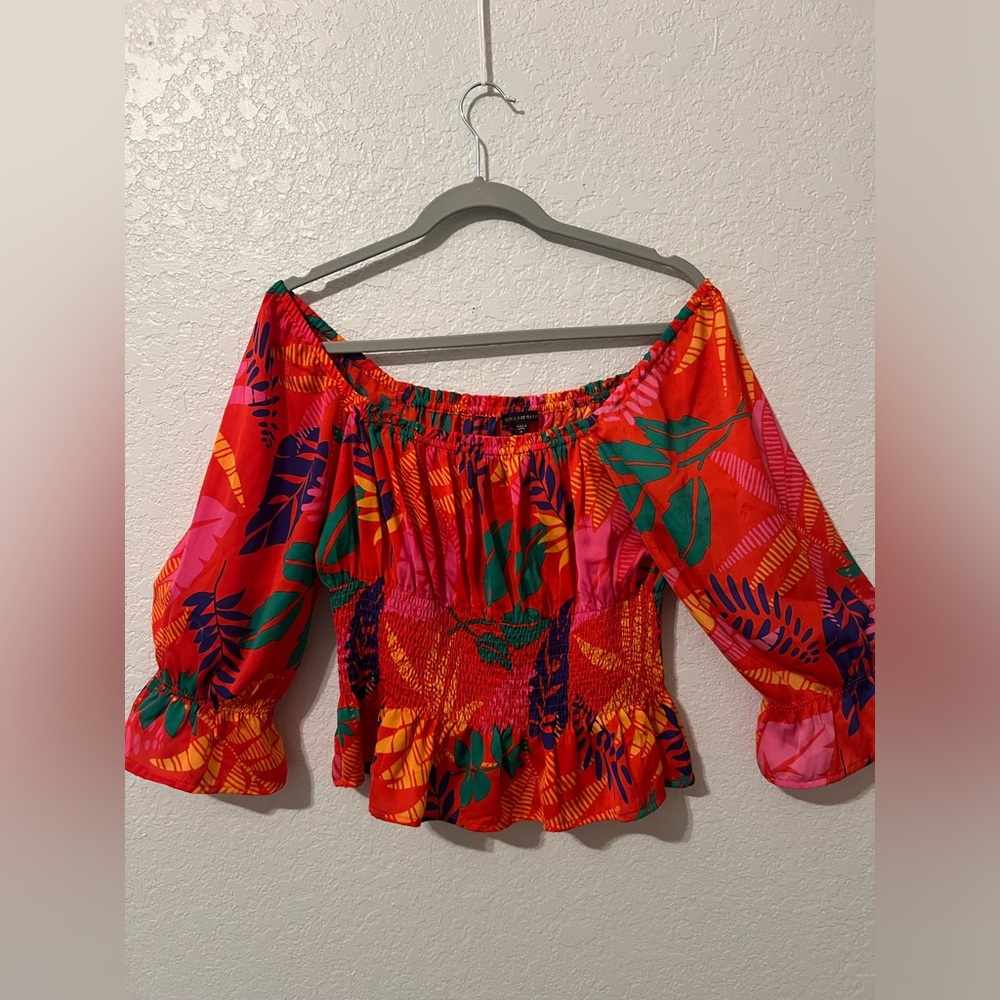 skies are blue. size medium. and has a tropical pattern